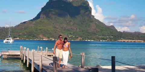 Couple walking on dock in Tahiti